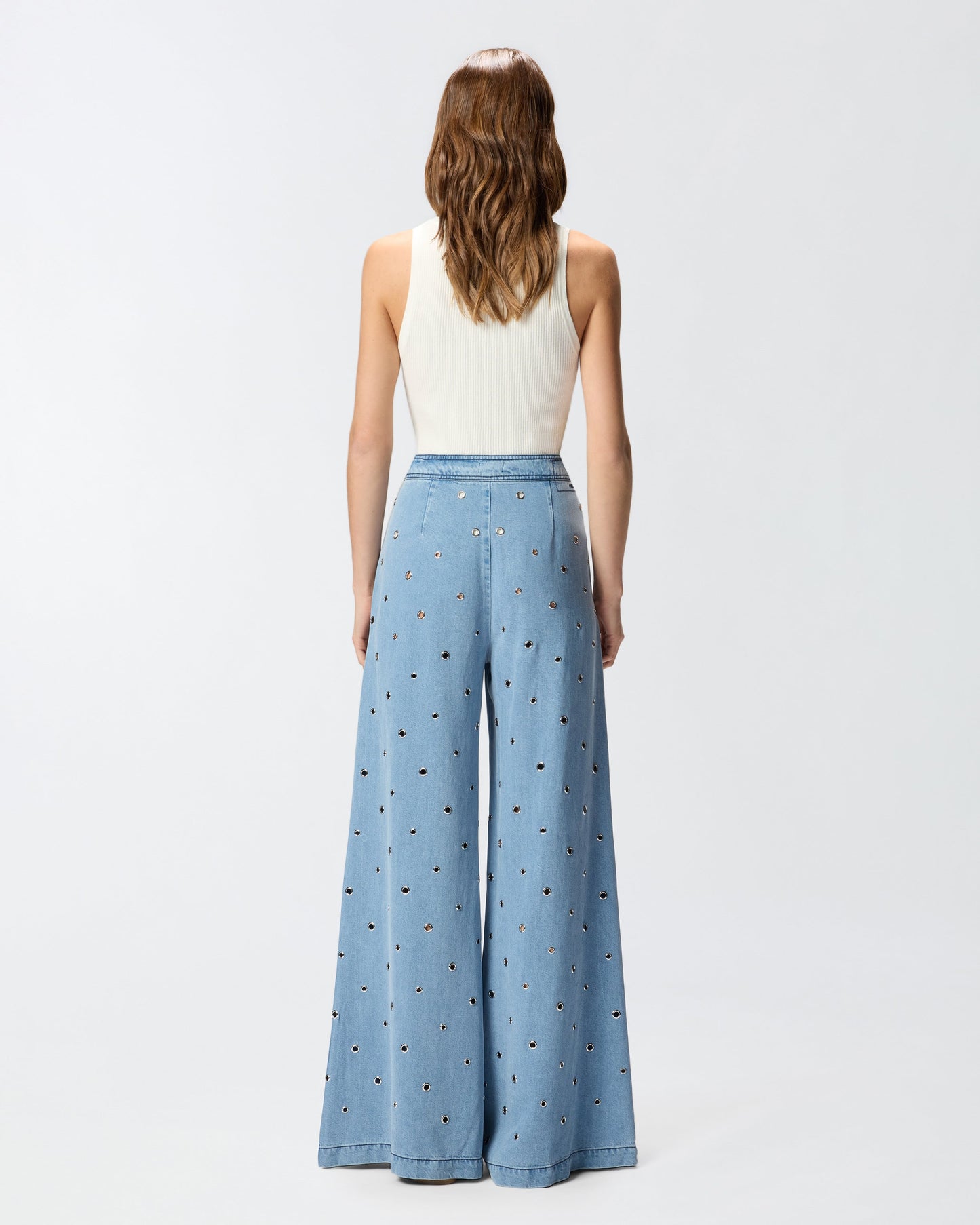 Denim jeans with eyelets